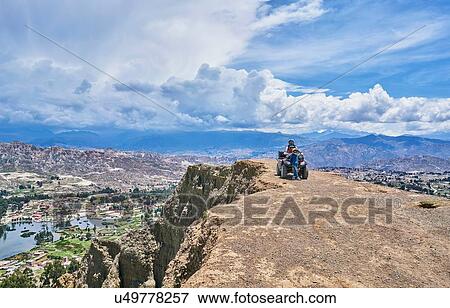 Stock Photo - Mother and sons beside quad bike, on mountain top, La Paz, Bolivia, South America. Fotosearch