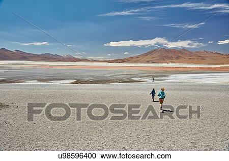 Stock Image - Mother and sons exploring landscape, Laguna Colorada, Colorada, Potosi, Bolivia, South America. Fotosearch