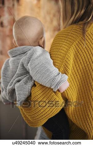 Mother holding baby boy (12-17 months) View Large Photo Image Stock Image - Mother holding baby boy (12-17 months). Fotosearch