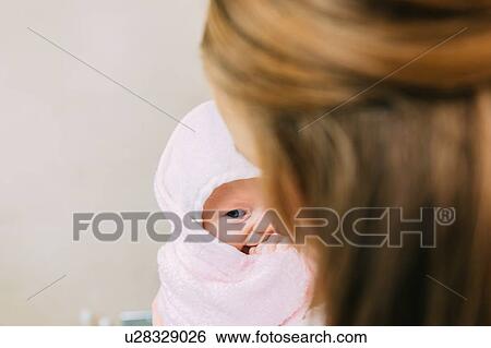 Mother holding baby daughter wrapped in towel View Large Photo Image Stock Photograph - Mother holding baby daughter wrapped in towel. Fotosearch