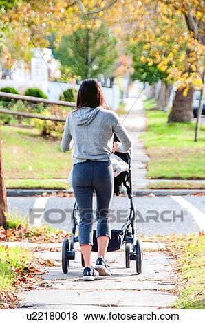 Mother walking baby in pram View Large Photo Image Stock Photo - Mother walking baby in pram. Fotosearch