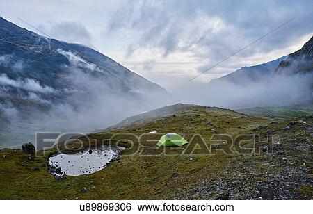 Stock Photograph - Mountain view with tent on hill, Ventilla, La Paz, Bolivia, South America. Fotosearch