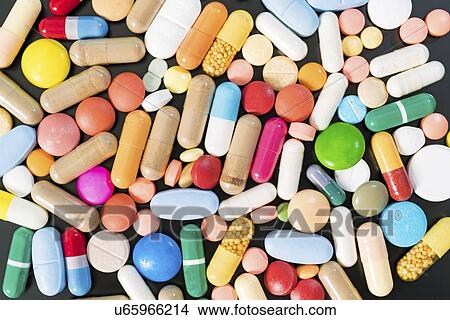 Multicolored pills and capsules on a black background. View Large Photo Image Picture - Multicolored pills and capsules on a black background.. Fotosearch