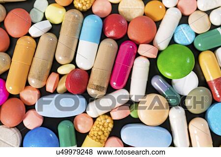 Multicolored pills and capsules on a black background. View Large Photo Image Stock Photo - Multicolored pills and capsules on a black background.. Fotosearch