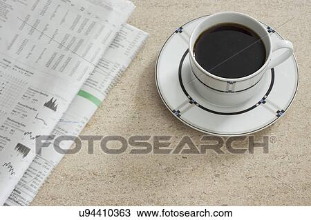 Newspaper and coffee on table View Large Photo Image Stock Image - Newspaper and coffee on table. Fotosearch