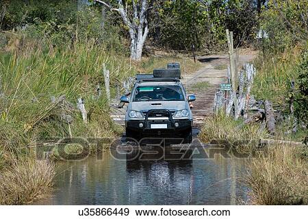 Off road vehicle crossing water in the Moremi Game Reserve, Okavango Delta, Botswana View Large Photo Image Stock Photo - Off road vehicle crossing water in the Moremi Game Reserve, Okavango Delta, Botswana. Fotosearch