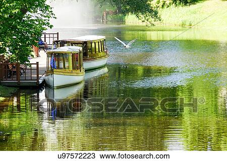 Old wooden canal boats moored along canal, Riga, Latvia View Large Photo Image Stock Image - Old wooden canal boats moored along canal, Riga, Latvia. Fotosearch