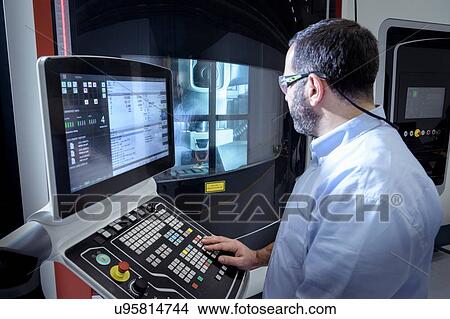 Operator with stainless steel 3D printer in robotics research facility View Large Photo Image Picture - Operator with stainless steel 3D printer in robotics research facility. Fotosearch