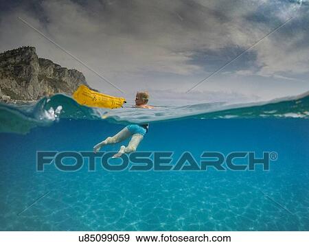 Over underwater view of boy looking back while swimming in blue sea, Varigotti, Liguria, Italy View Large Photo Image Stock Photo - Over underwater view of boy looking back while swimming in blue sea, Varigotti, Liguria, Italy. Fotosearch