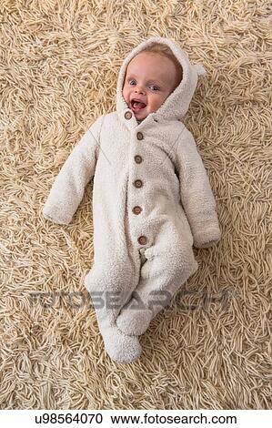 Overhead portrait of cute baby boy in furry babygro View Large Photo Image Stock Image - Overhead portrait of cute baby boy in furry babygro. Fotosearch
