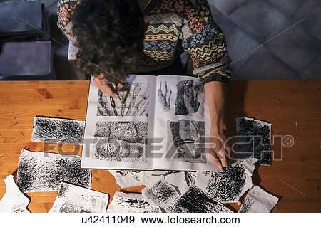 Overhead view of male artist drawing in sketchbook in artists studio View Large Photo Image Stock Photo - Overhead view of male artist drawing in sketchbook in artists studio. Fotosearch