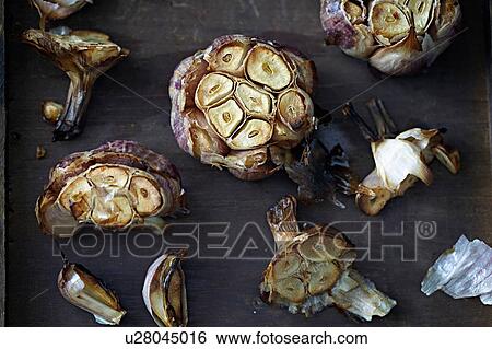 Stock Photograph - Overhead view of roasted garlic bulbs. Fotosearch
