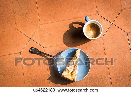 Stock Image - Overhead view of slice of cake and coffee. Fotosearch