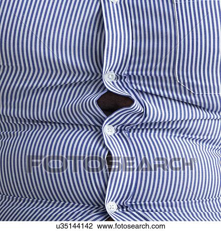 Stock Image - Overweight man wearing blue striped shirt with bulging buttons.. Fotosearch