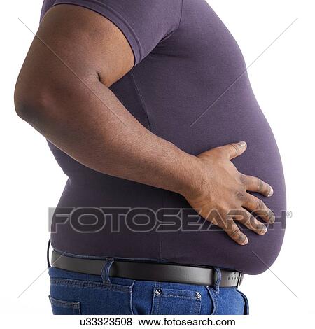 Stock Photo - Overweight man with his hand on his stomach, side view.. Fotosearch