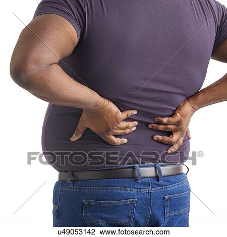 Stock Image - Overweight man with his hands on his back.. Fotosearch