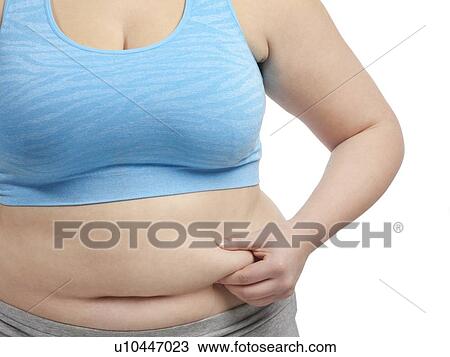 Overweight woman holding the fat around her waist. View Large Photo Image Stock Image - Overweight woman holding the fat around her waist.. Fotosearch