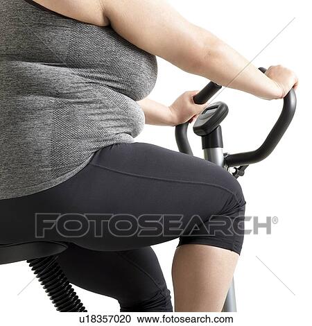 Overweight woman on exercise bike. View Large Photo Image Stock Image - Overweight woman on exercise bike.. Fotosearch