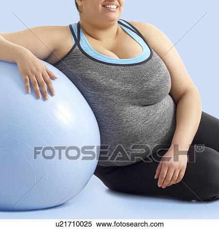 Overweight woman resting against exercise ball. View Large Photo Image Stock Photography - Overweight woman resting against exercise ball.. Fotosearch