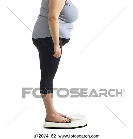 Overweight woman standing on weighing scales. View Large Photo Image Stock Image - Overweight woman standing on weighing scales.. Fotosearch