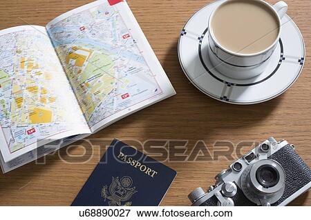 Passport, coffee, old camera and open guidebook View Large Photo Image Stock Photo - Passport, coffee, old camera and open guidebook. Fotosearch