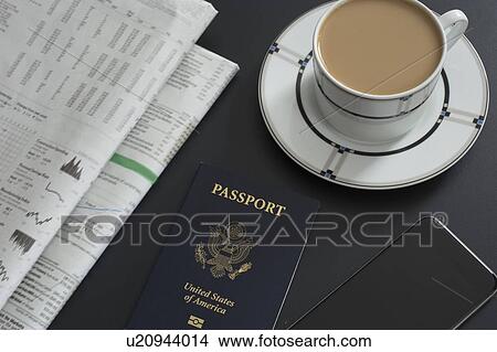 Picture - Passport, newspaper, smart phone and coffee on table. Fotosearch