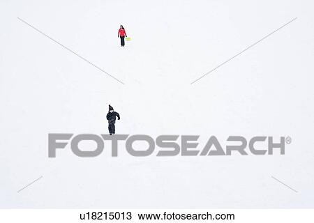 Stock Image - People walking in snow. Fotosearch