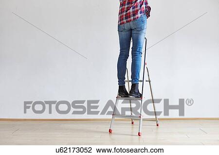 Person standing on ladder View Large Photo Image Stock Image - Person standing on ladder. Fotosearch