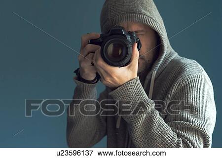 Stock Photo - Photographer holding full frame sensor DSLR camera.. Fotosearch