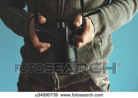 Stock Photo - Photographer holding full frame sensor DSLR camera.. Fotosearch