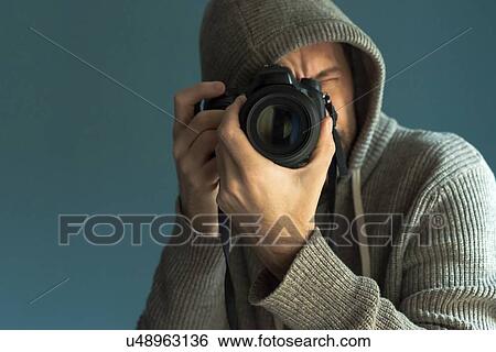 Photographer holding full frame sensor DSLR camera. View Large Photo Image Stock Photograph - Photographer holding full frame sensor DSLR camera.. Fotosearch
