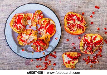 Plate of pomegranate pieces and seeds on table View Large Photo Image Stock Image - Plate of pomegranate pieces and seeds on table. Fotosearch