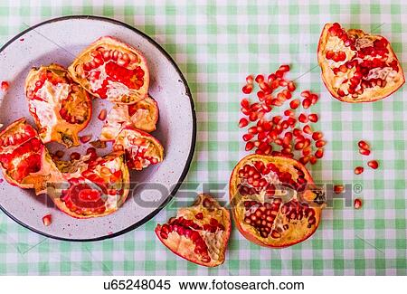 Plate of pomegranate pieces and seeds on table View Large Photo Image Stock Photography - Plate of pomegranate pieces and seeds on table. Fotosearch
