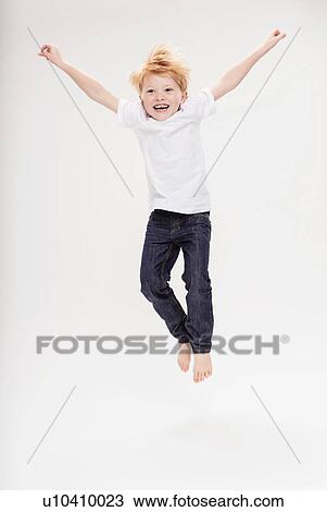 Portrait of boy leaping in air View Large Photo Image Stock Image - Portrait of boy leaping in air. Fotosearch