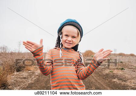 Portrait of boy on in rural setting, gesturing with hands View Large Photo Image Picture - Portrait of boy on in rural setting, gesturing with hands. Fotosearch