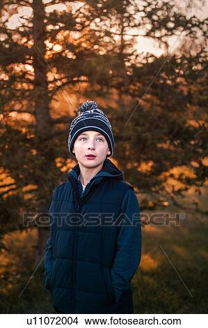 Picture - Portrait of boy, outdoors, looking away. Fotosearch