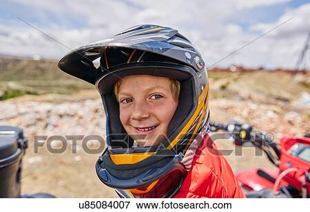 Stock Photo - Portrait of boy wearing crash helmet, close-up, La Paz, Bolivia, South America. Fotosearch