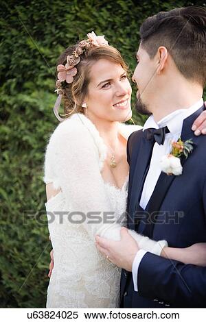 Portrait of bride and bridegroom, hedge in background View Large Photo Image Stock Photography - Portrait of bride and bridegroom, hedge in background. Fotosearch