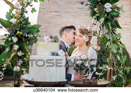 Portrait of bride and bridegroom with wedding cake View Large Photo Image Picture - Portrait of bride and bridegroom with wedding cake. Fotosearch