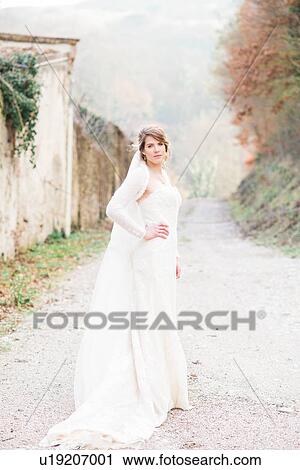 Portrait of bride on country lane View Large Photo Image Stock Image - Portrait of bride on country lane. Fotosearch