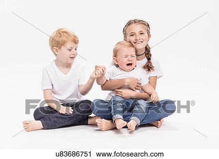 Stock Image - Portrait of brothers and sister. Fotosearch