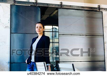 Portrait of businesswoman in office, smiling View Large Photo Image Picture - Portrait of businesswoman in office, smiling. Fotosearch