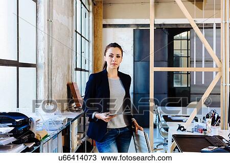 Stock Image - Portrait of businesswoman in office. Fotosearch