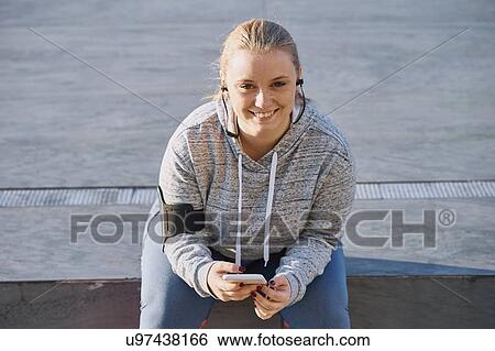 Portrait of curvaceous young woman training, sitting on wall View Large Photo Image Stock Photograph - Portrait of curvaceous young woman training, sitting on wall. Fotosearch