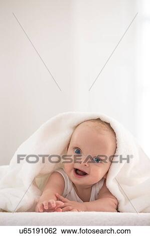 Portrait of cute baby boy wrapped in white towel View Large Photo Image Stock Image - Portrait of cute baby boy wrapped in white towel. Fotosearch