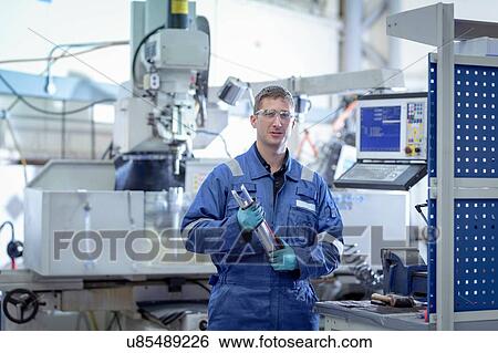 Portrait of engineer with lathe in turbine maintenance factory View Large Photo Image Stock Photograph - Portrait of engineer with lathe in turbine maintenance factory. Fotosearch