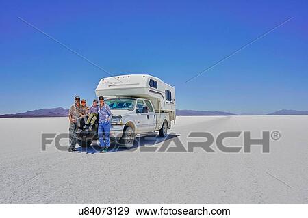 Portrait of family, standing in front of parked recreational vehicle, Salar de Uyuni, Uyuni, Oruro, Bolivia, South America View Large Photo Image Stock Photo - Portrait of family, standing in front of parked recreational vehicle, Salar de Uyuni, Uyuni, Oruro, Bolivia, South America. Fotosearch