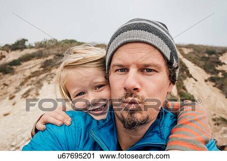 Portrait of father and son, outdoors, smiling, close-up View Large Photo Image Stock Image - Portrait of father and son, outdoors, smiling, close-up. Fotosearch
