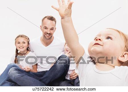 Stock Image - Portrait of father with daughter and sons. Fotosearch