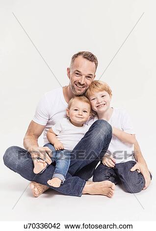 Stock Image - Portrait of father with sons. Fotosearch